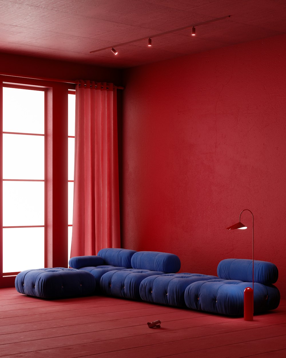 a living room with red walls and a blue couch