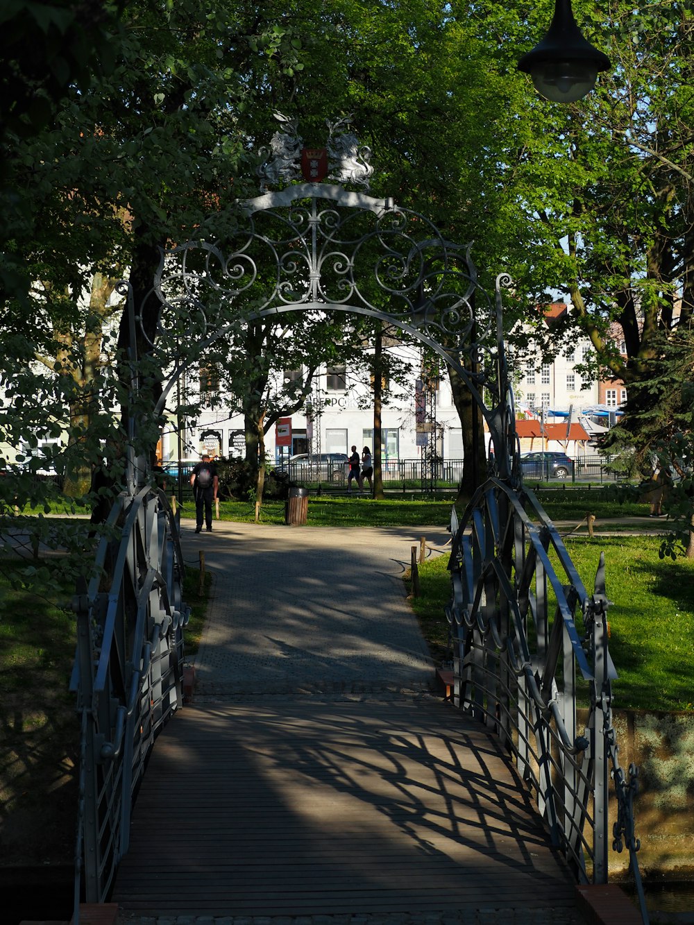 a walkway leading to a white building with a clock on it