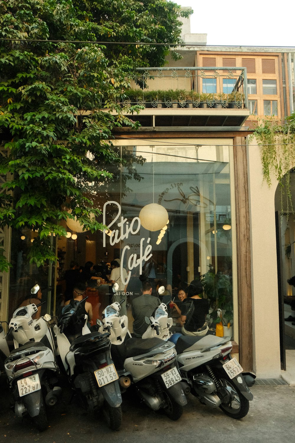 a group of motorcycles parked in front of a cafe