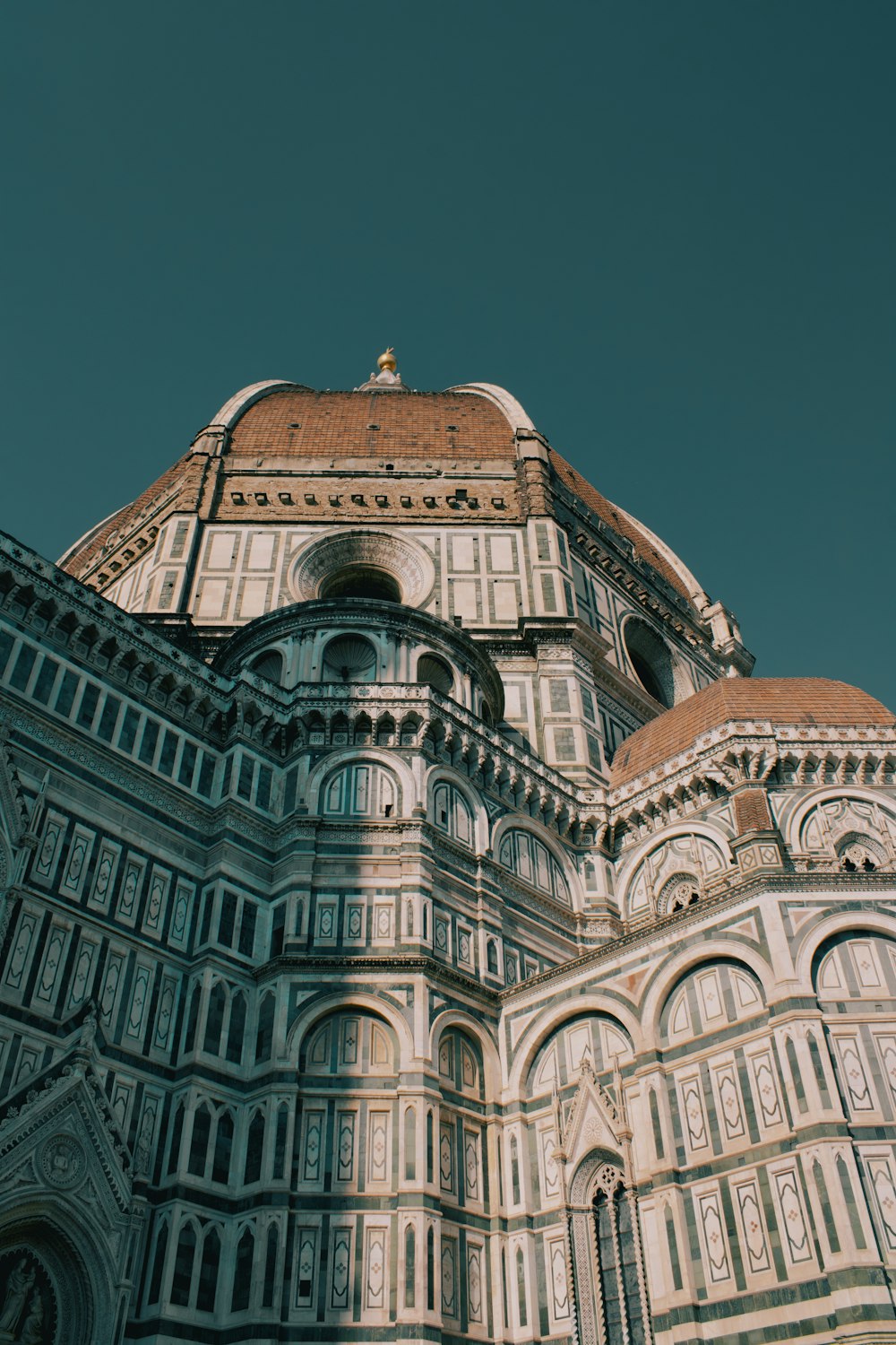 a very tall building with a clock on it's side