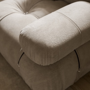 a close up of a couch with a pillow on top of it