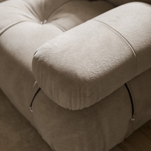 a close up of a couch with a pillow on top of it