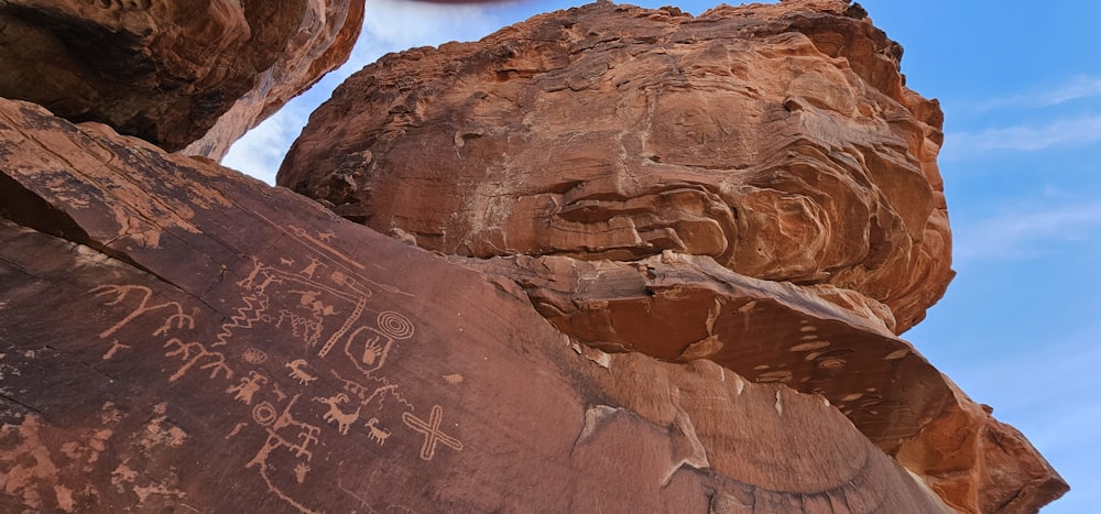 a rock with writing on it and a clock in the background