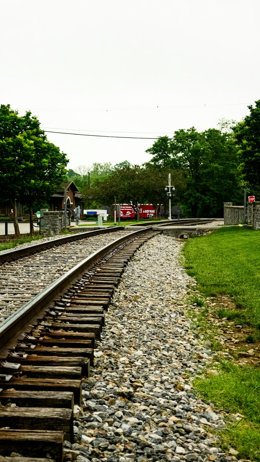 a train track running through a grassy area