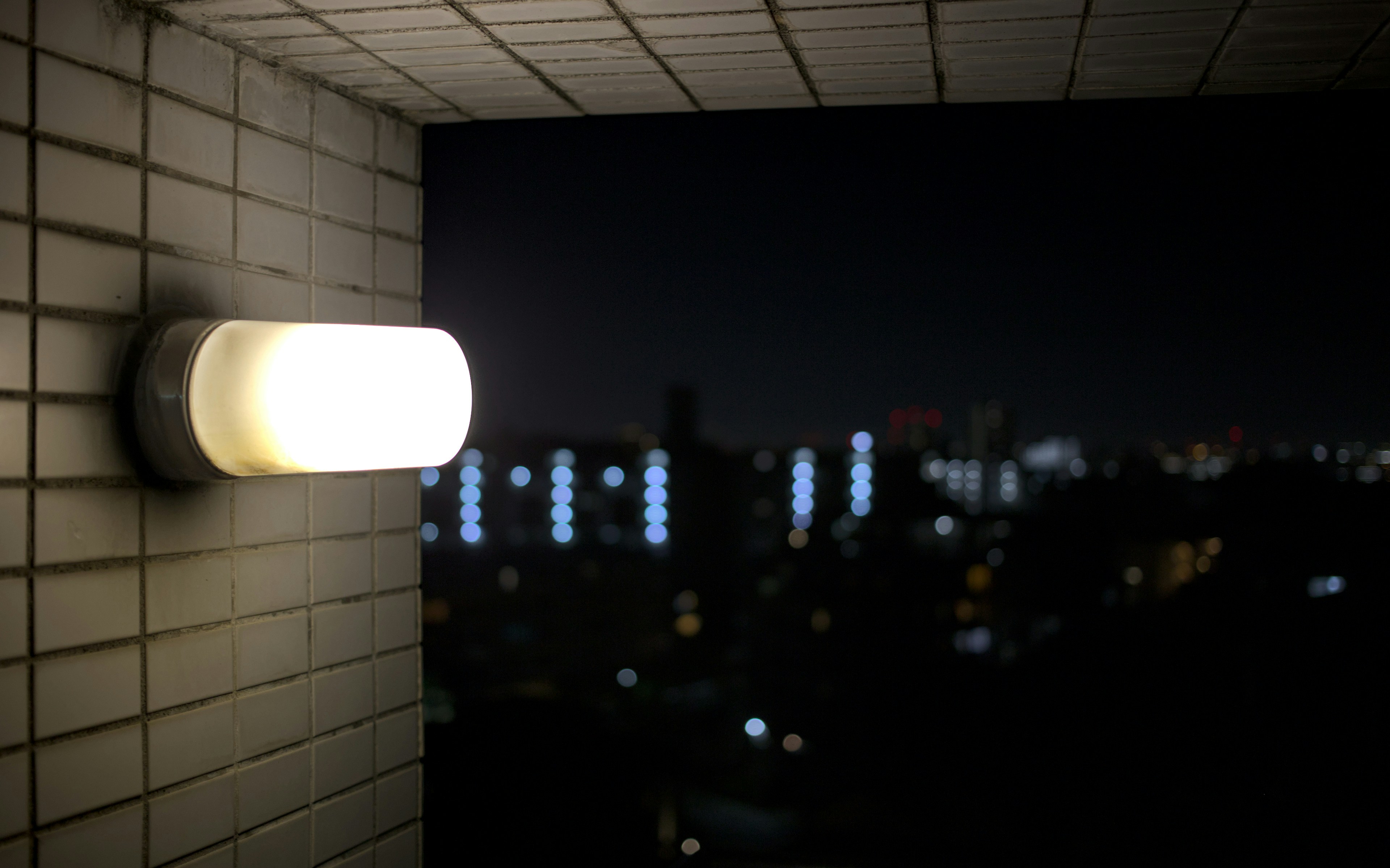 Dark room with a person holding a flashlight during a power outage in winter
