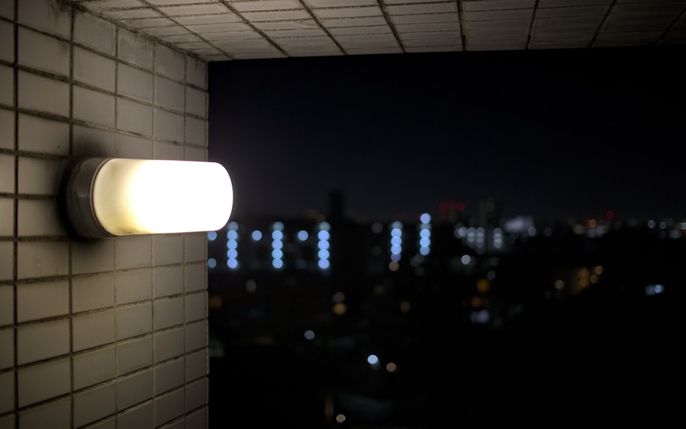 a wall mounted light on a brick wall