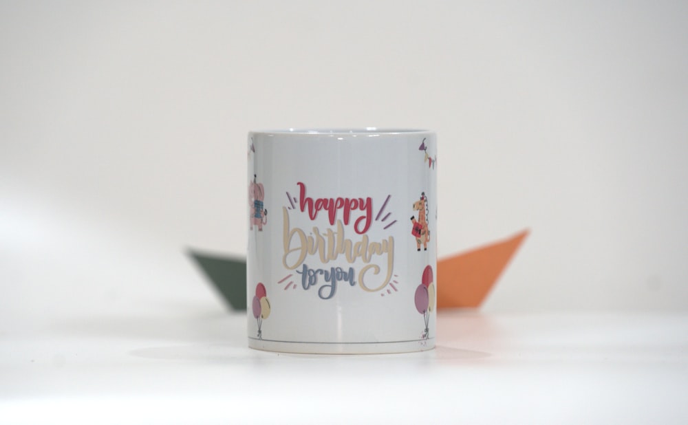 a white coffee mug with a happy birthday message on it