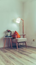 a room with a lamp, a chair and a table