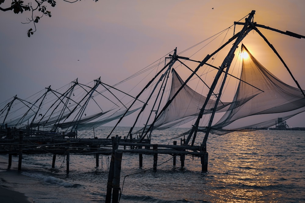 a row of fishing nets sitting on top of a body of water