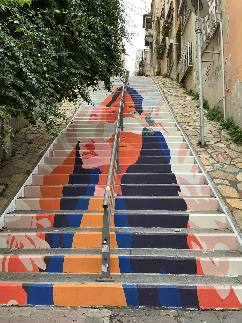 a set of stairs painted with a woman's face