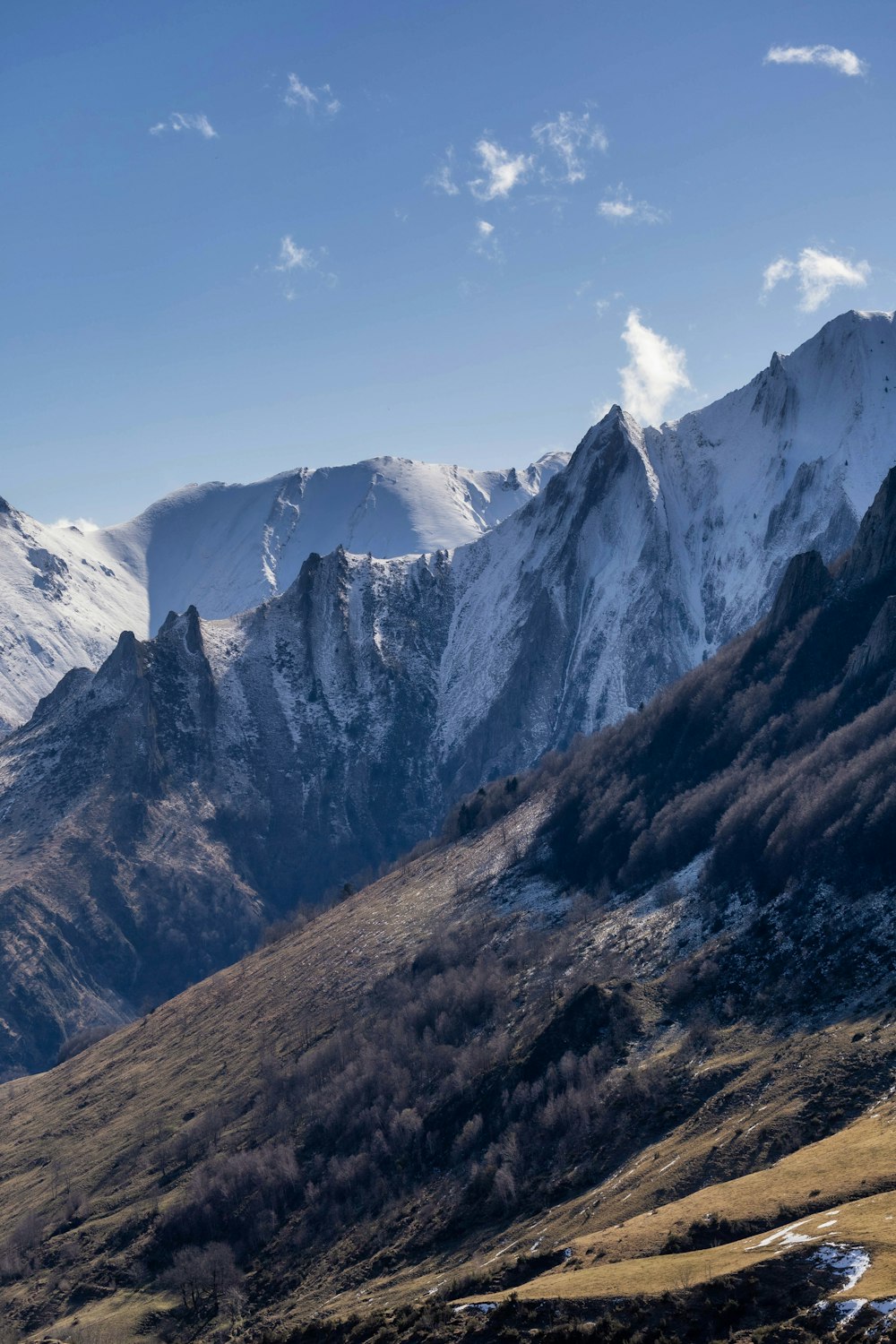 a mountain range with snow covered mountains in the background