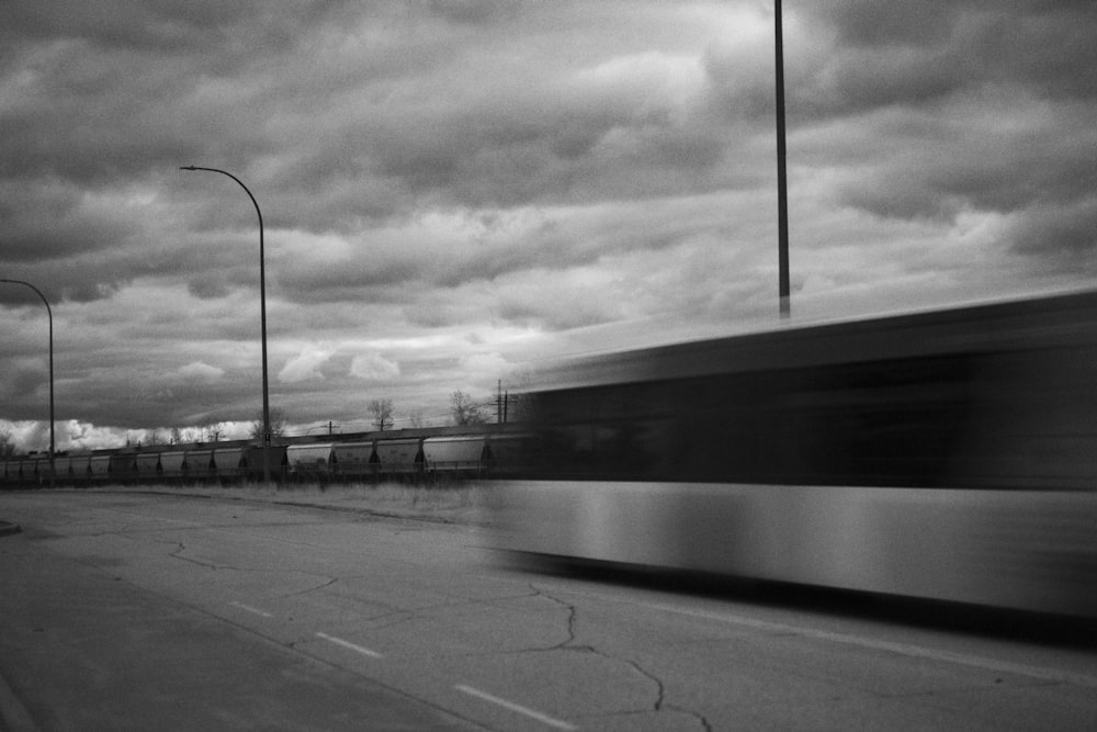 a black and white photo of a train passing by