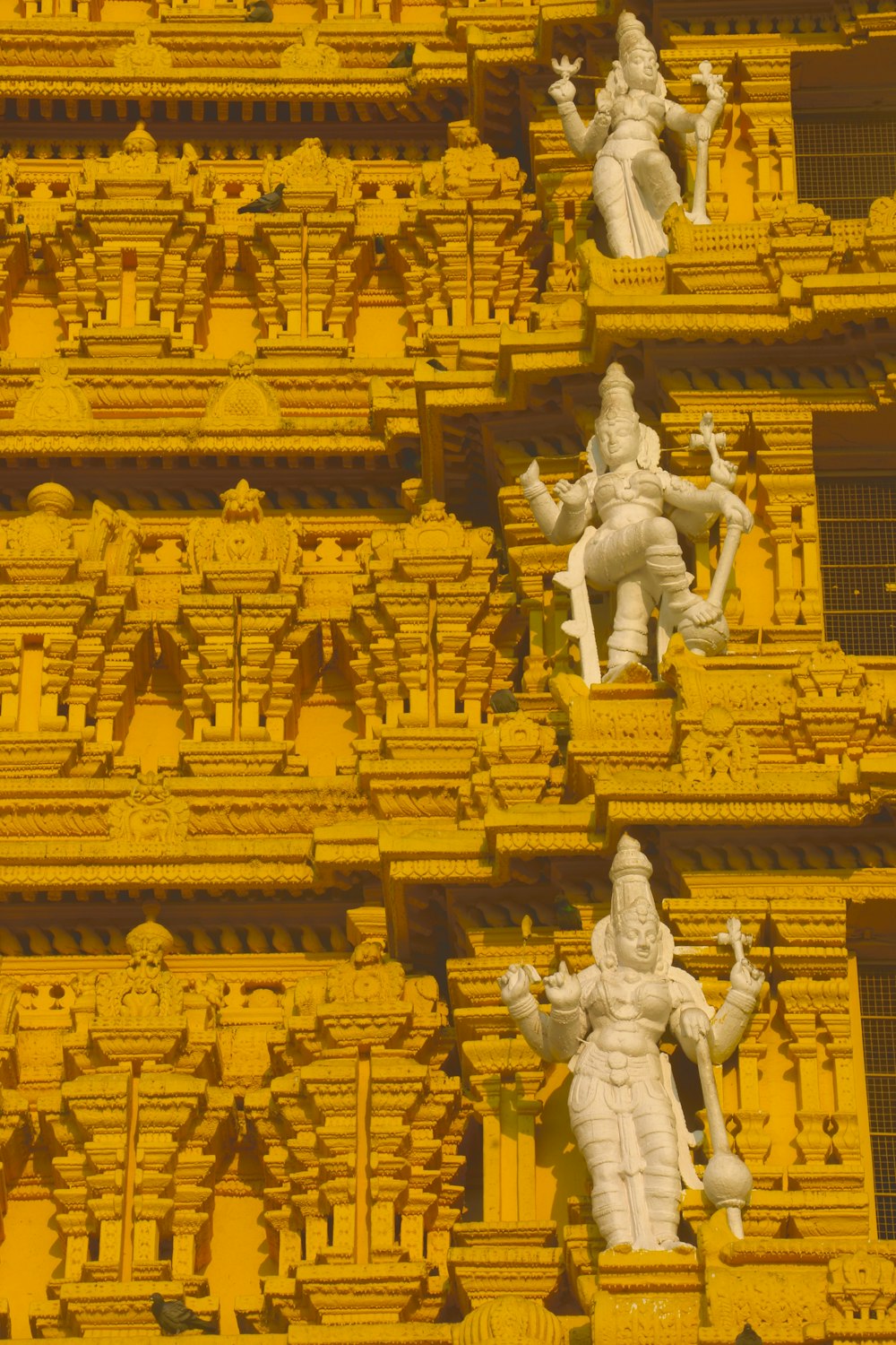 a close up of statues on the side of a building