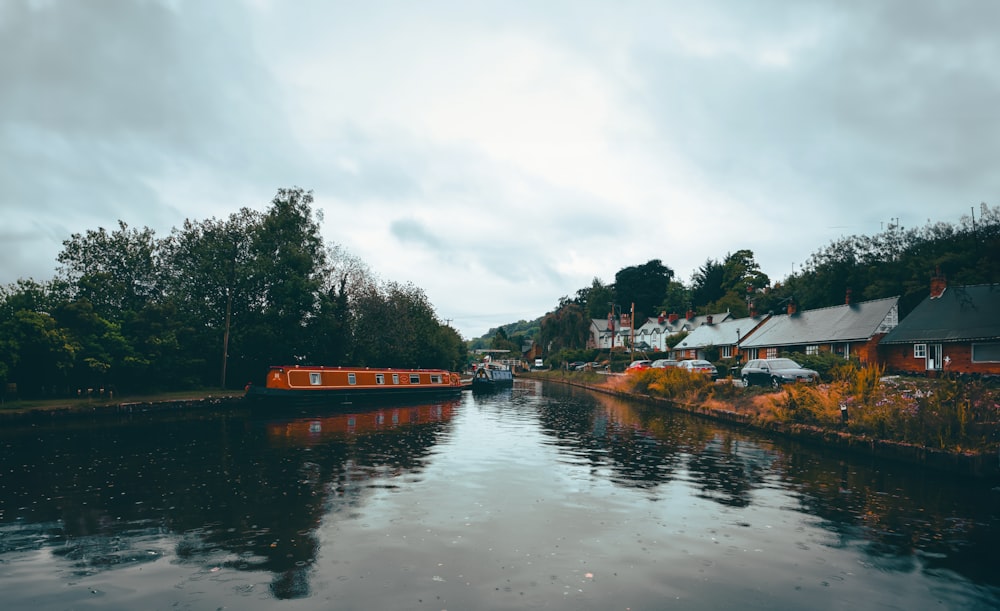 a boat is on the water near a row of houses