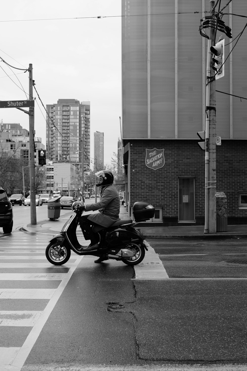 a man riding a motorcycle across a street
