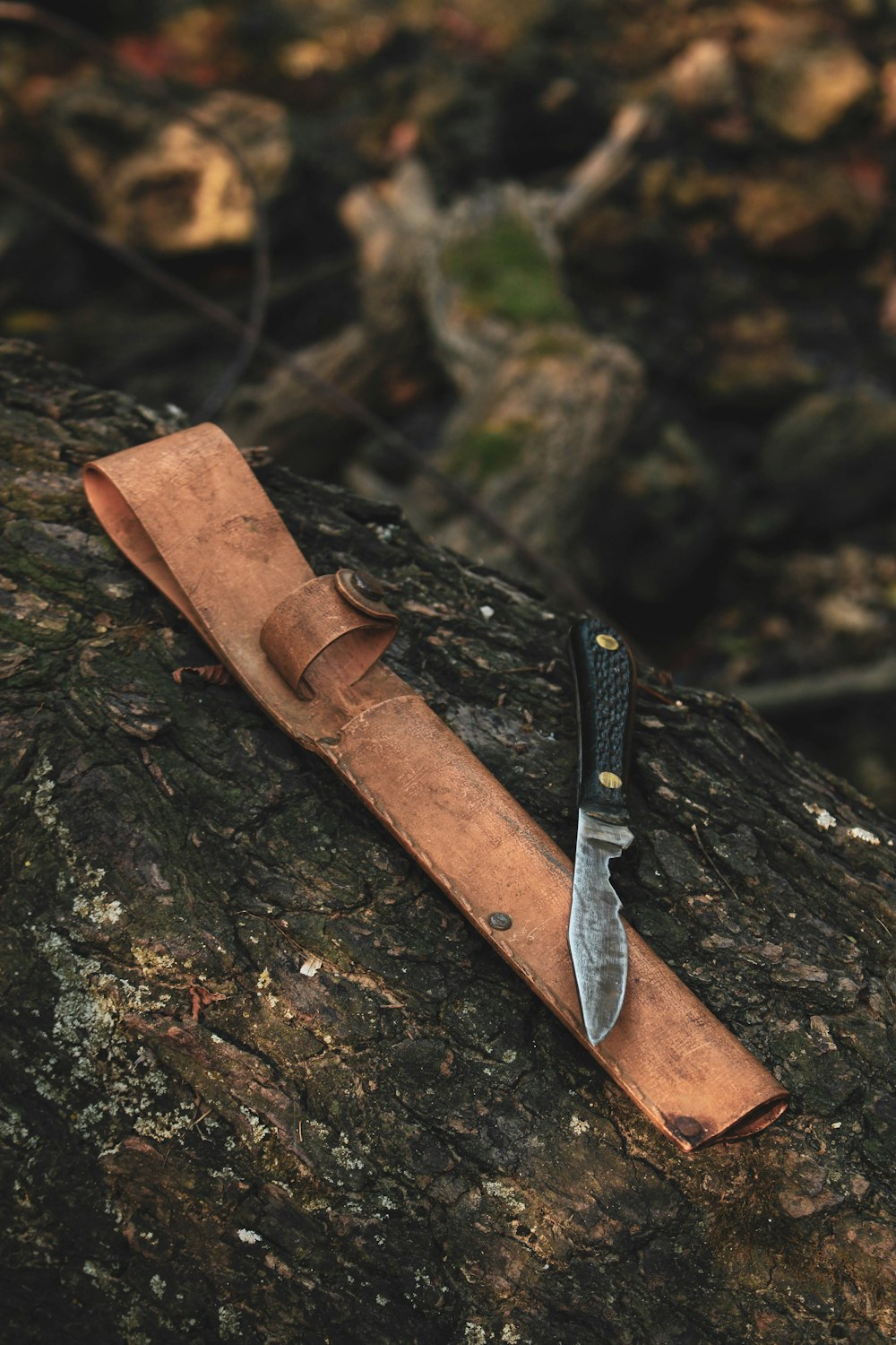 a knife sitting on top of a piece of leather