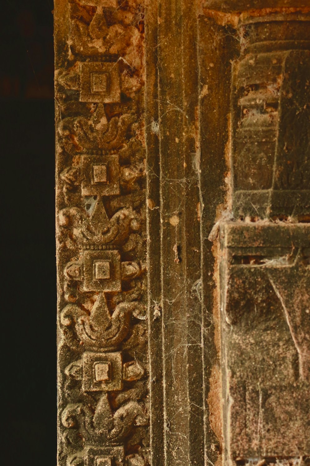 a close up of a wall with carvings on it