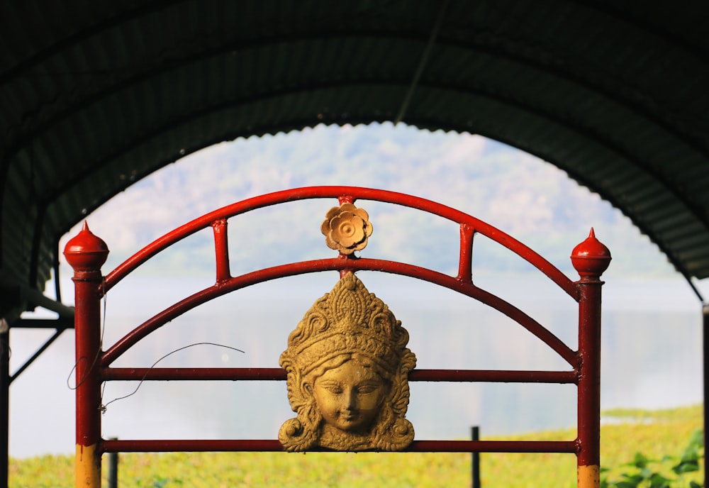 a statue of a woman on top of a red bench