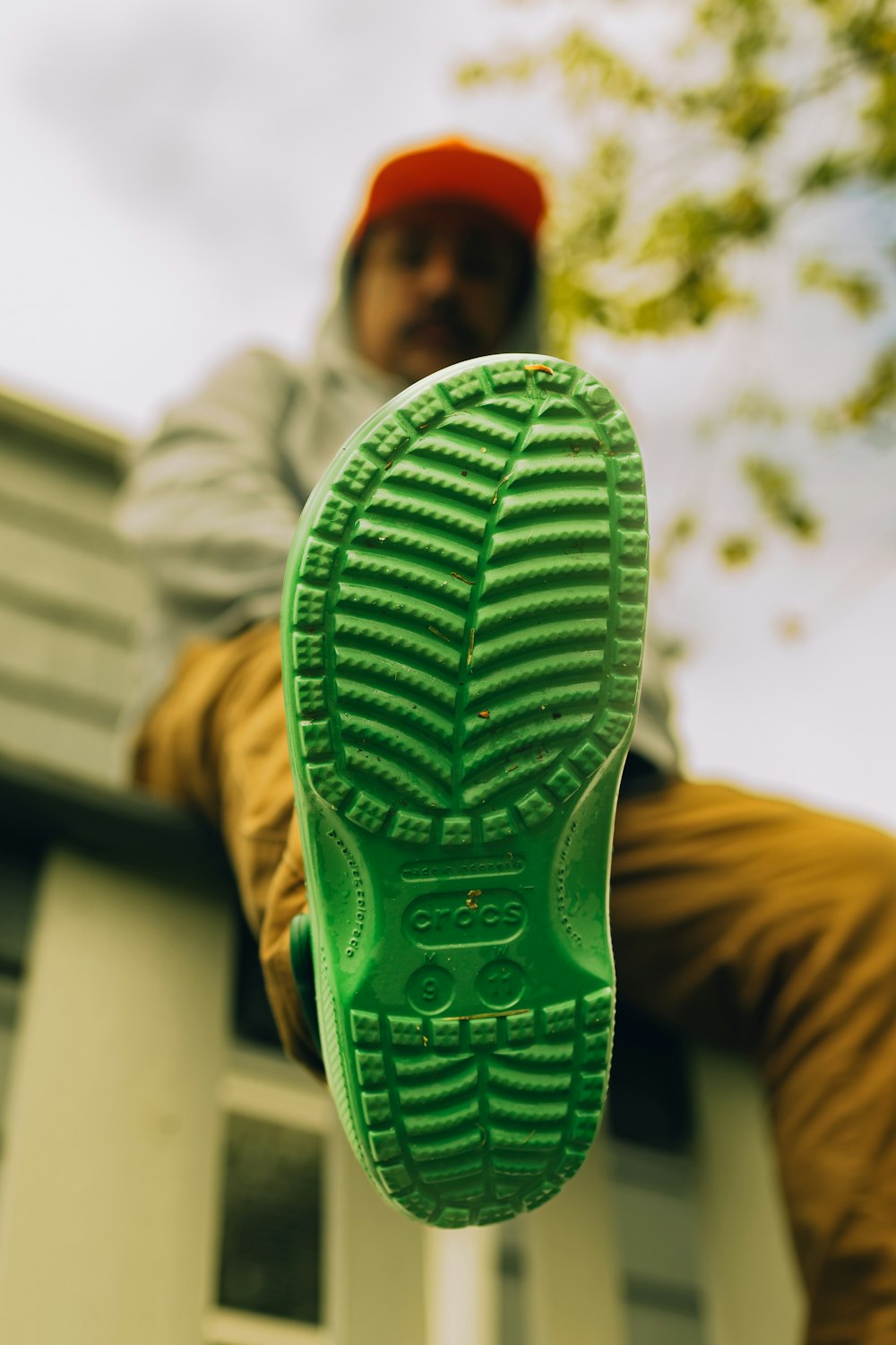 a man sitting on top of a green shoe