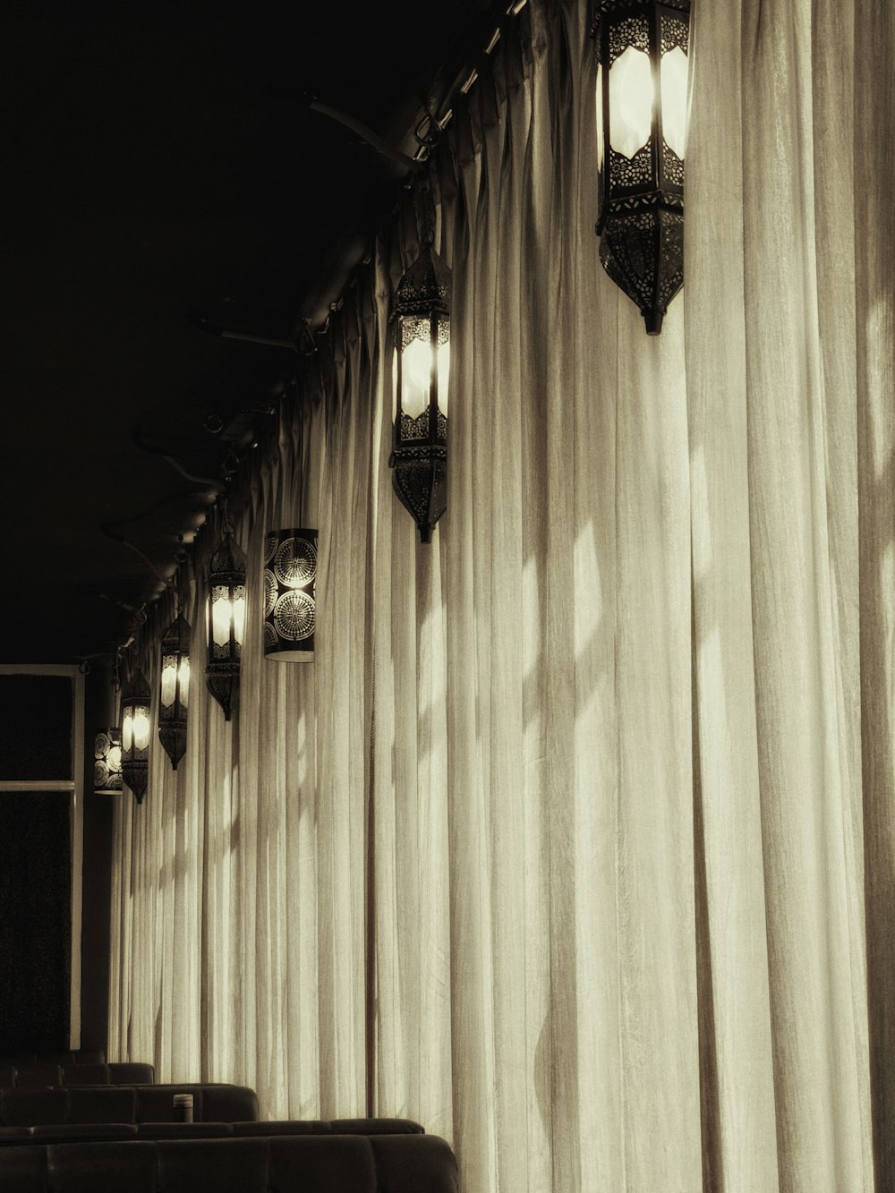 a row of lights hanging from the side of a wall