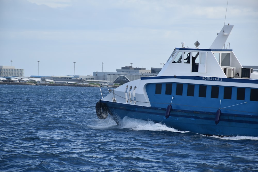 a blue and white boat in the water