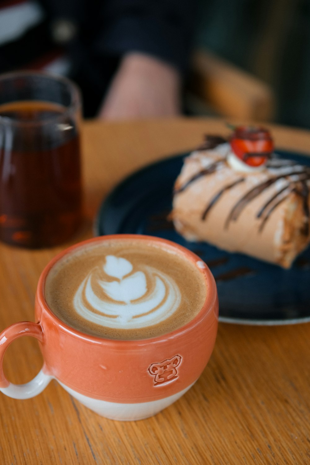 a cup of coffee and a piece of cake on a table