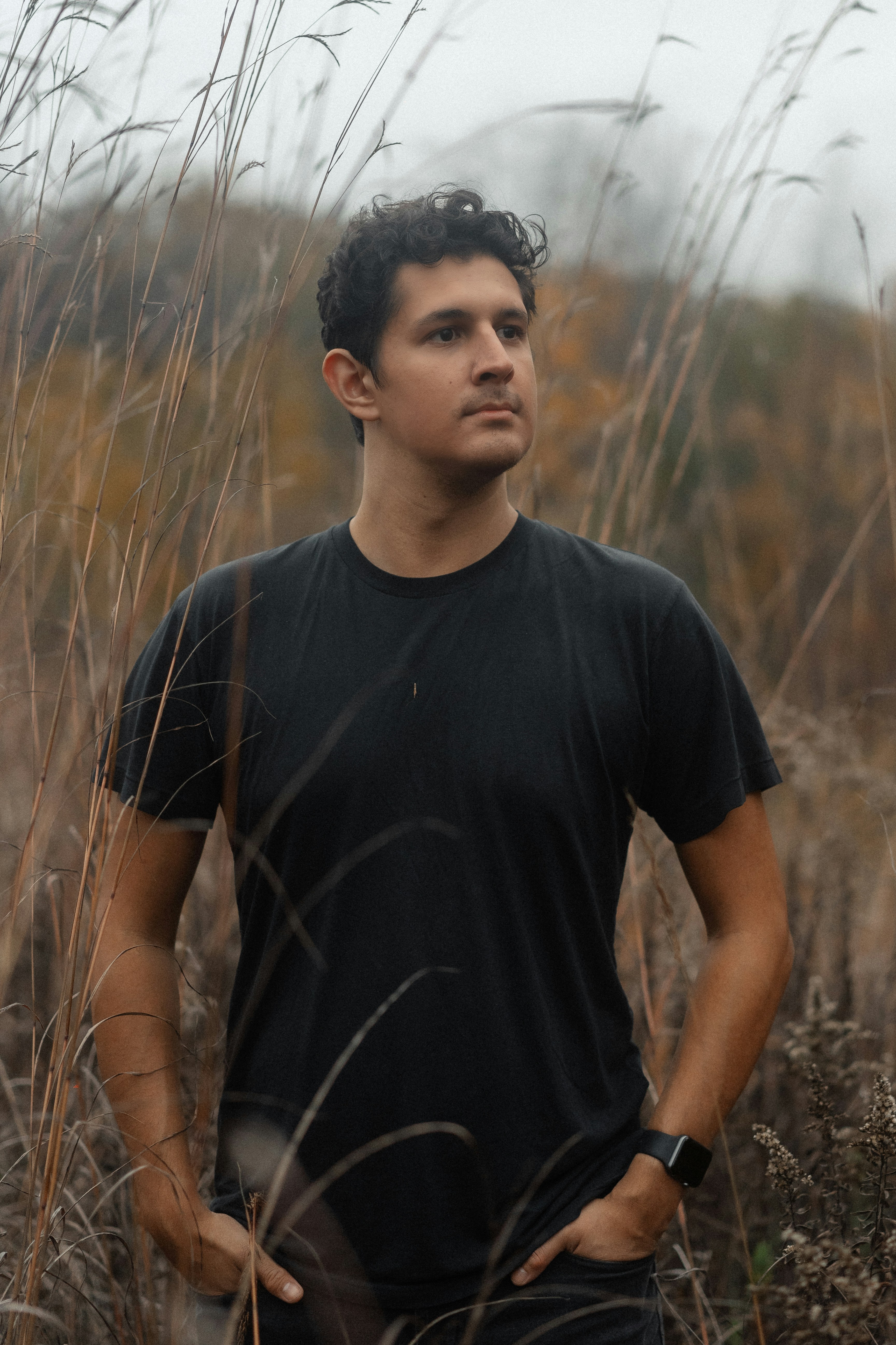 a man standing in a field of tall grass