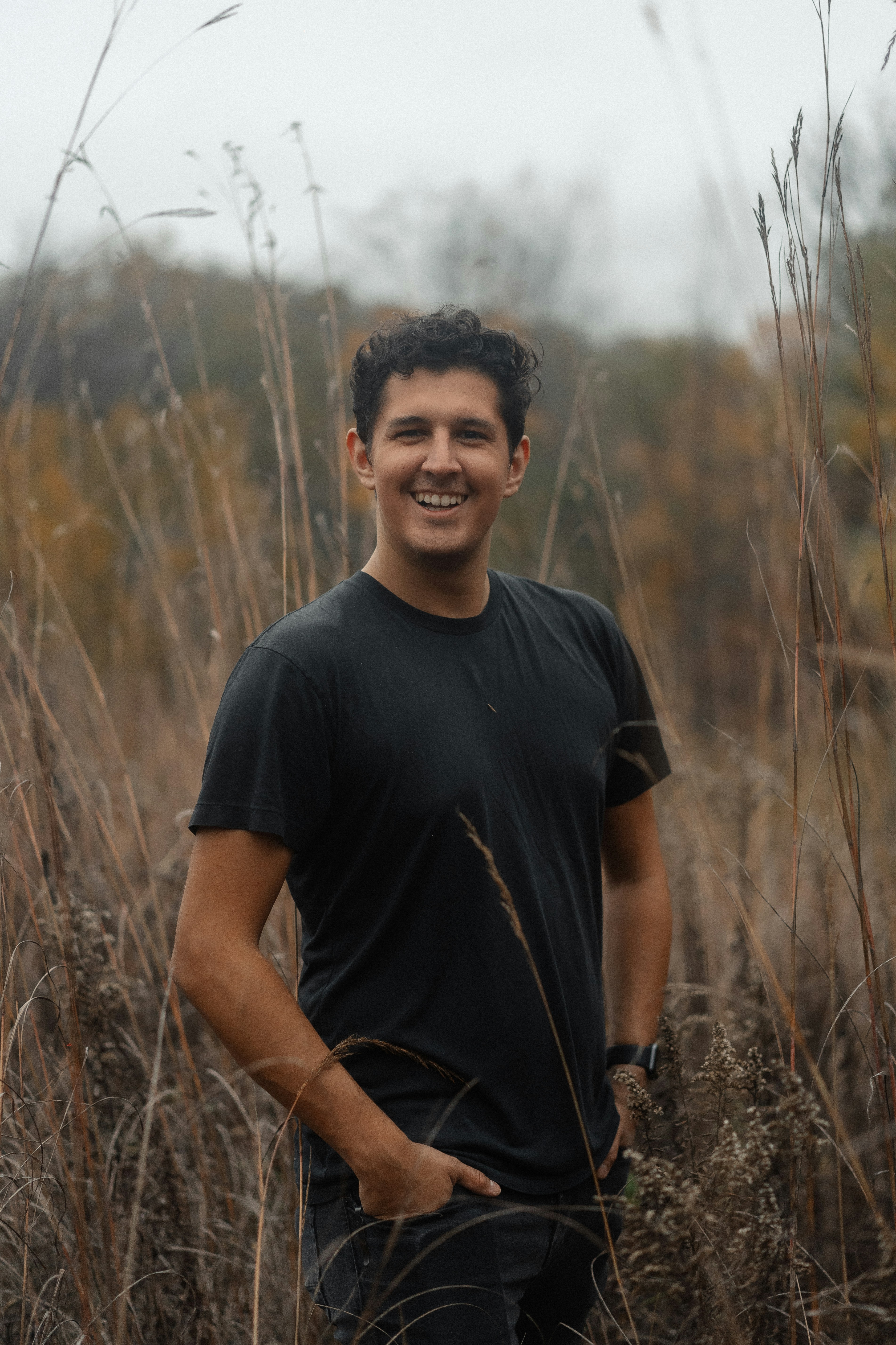 a man standing in a field of tall grass