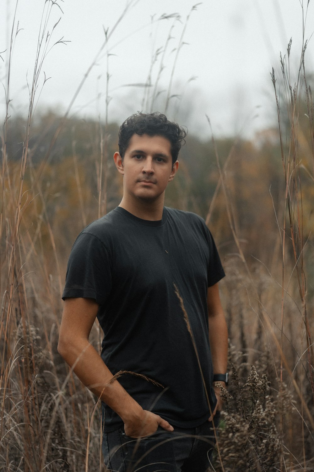 a man standing in a field of tall grass