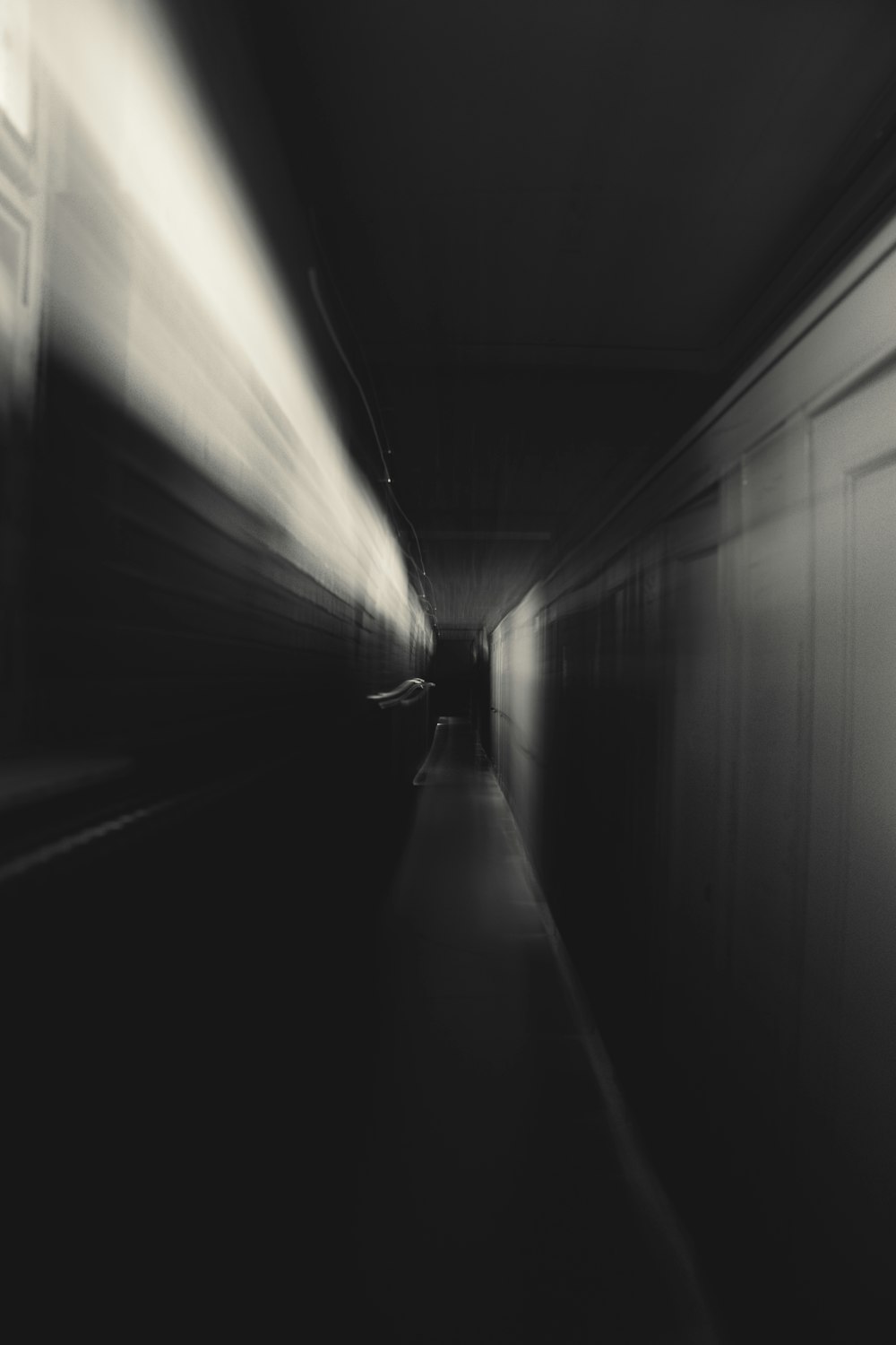 a black and white photo of a train passing by