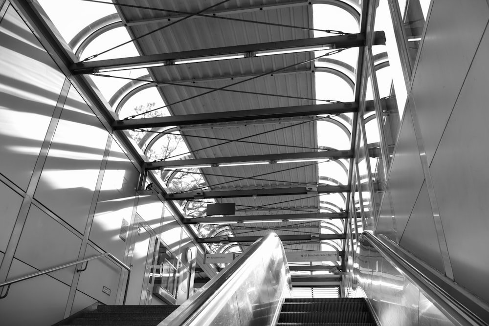 a black and white photo of an escalator