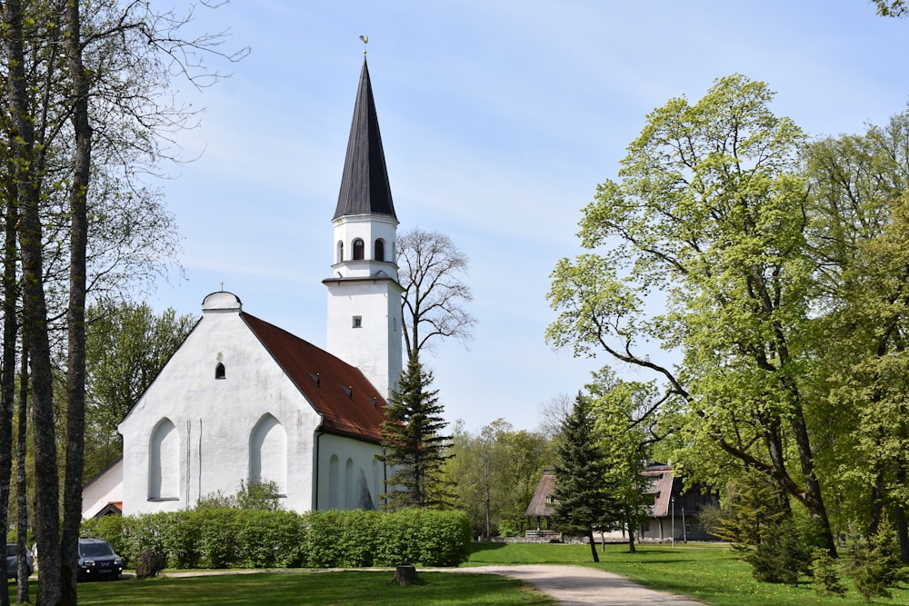 a white church with a red roof and a steeple