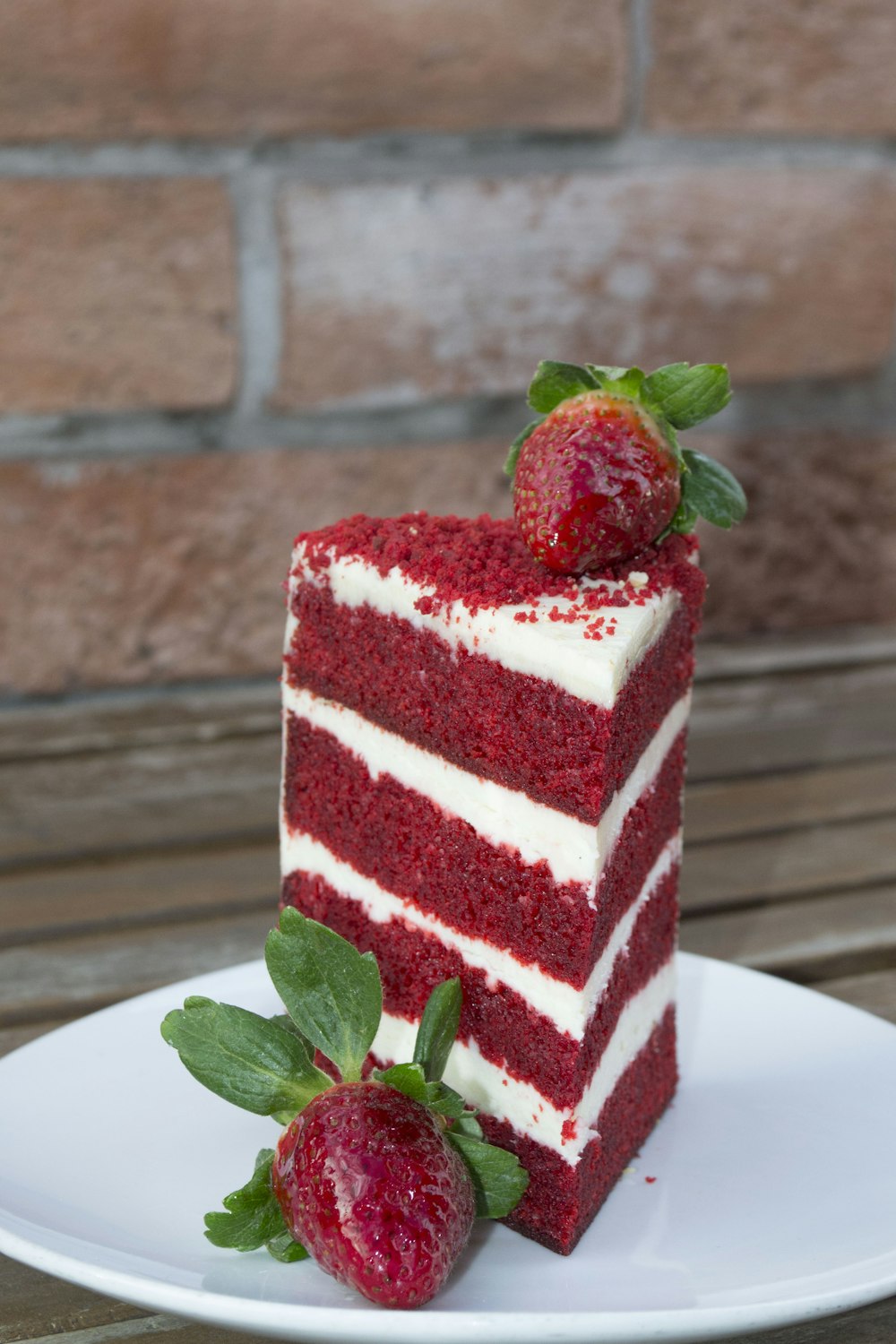 a slice of red velvet cake with strawberries on top