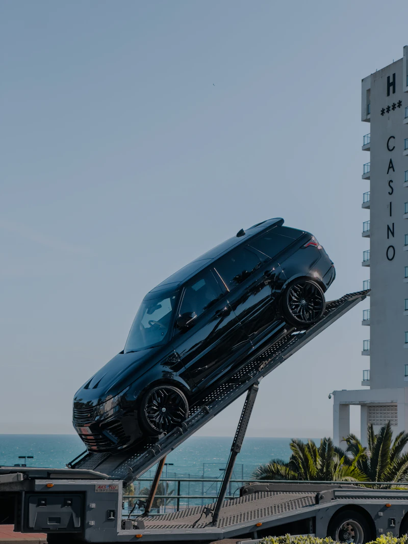 Car secured on a flatbed transport truck