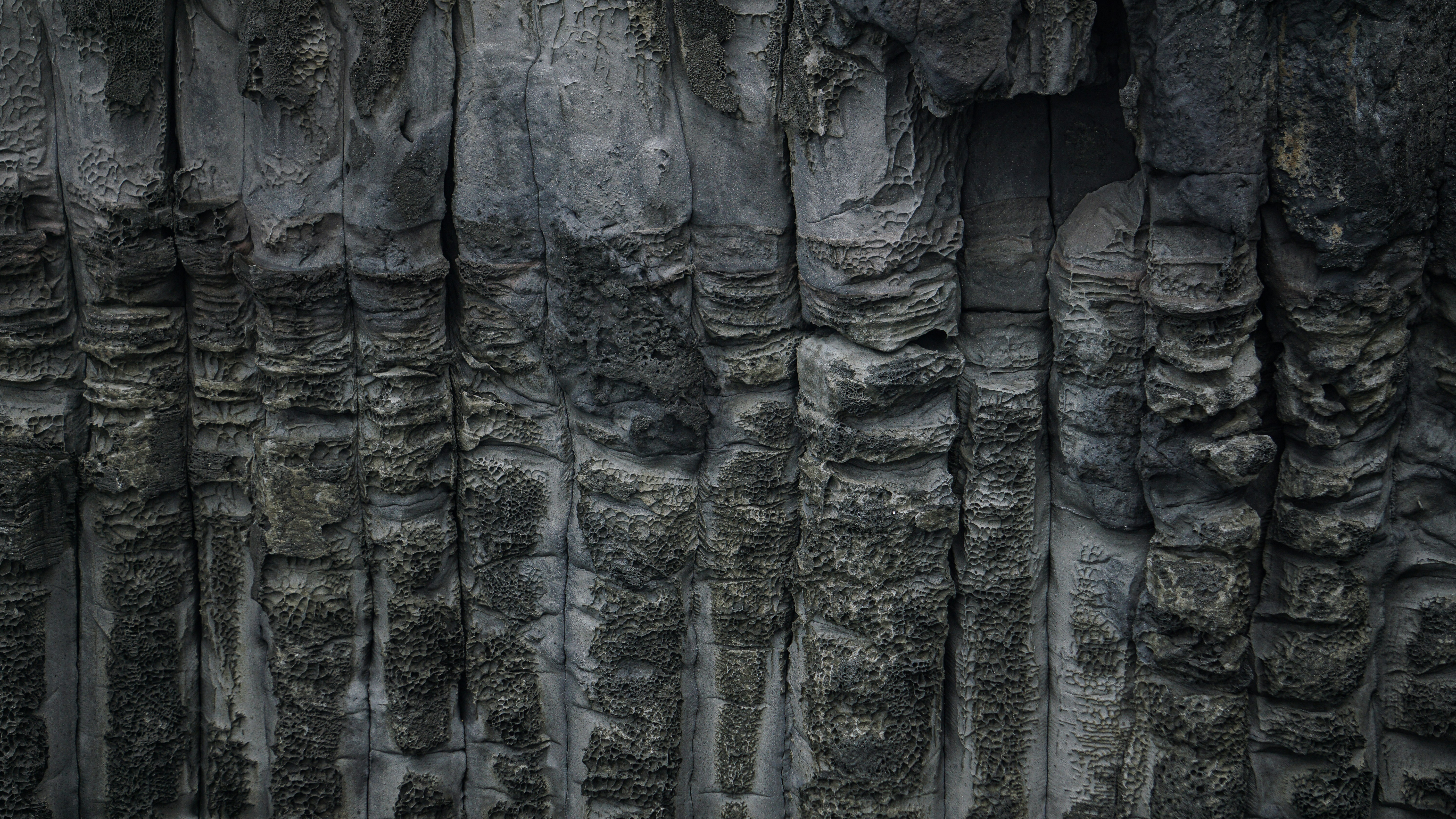a man standing in front of a stone wall, 