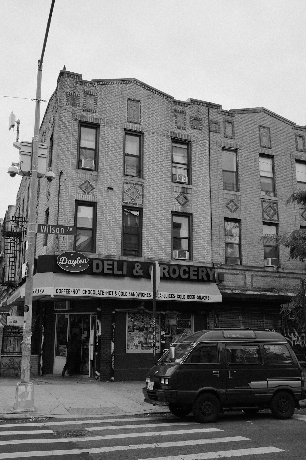 a black and white photo of a deli and grocery store