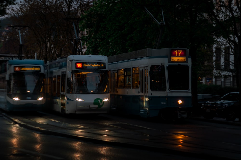 a couple of buses that are sitting in the street