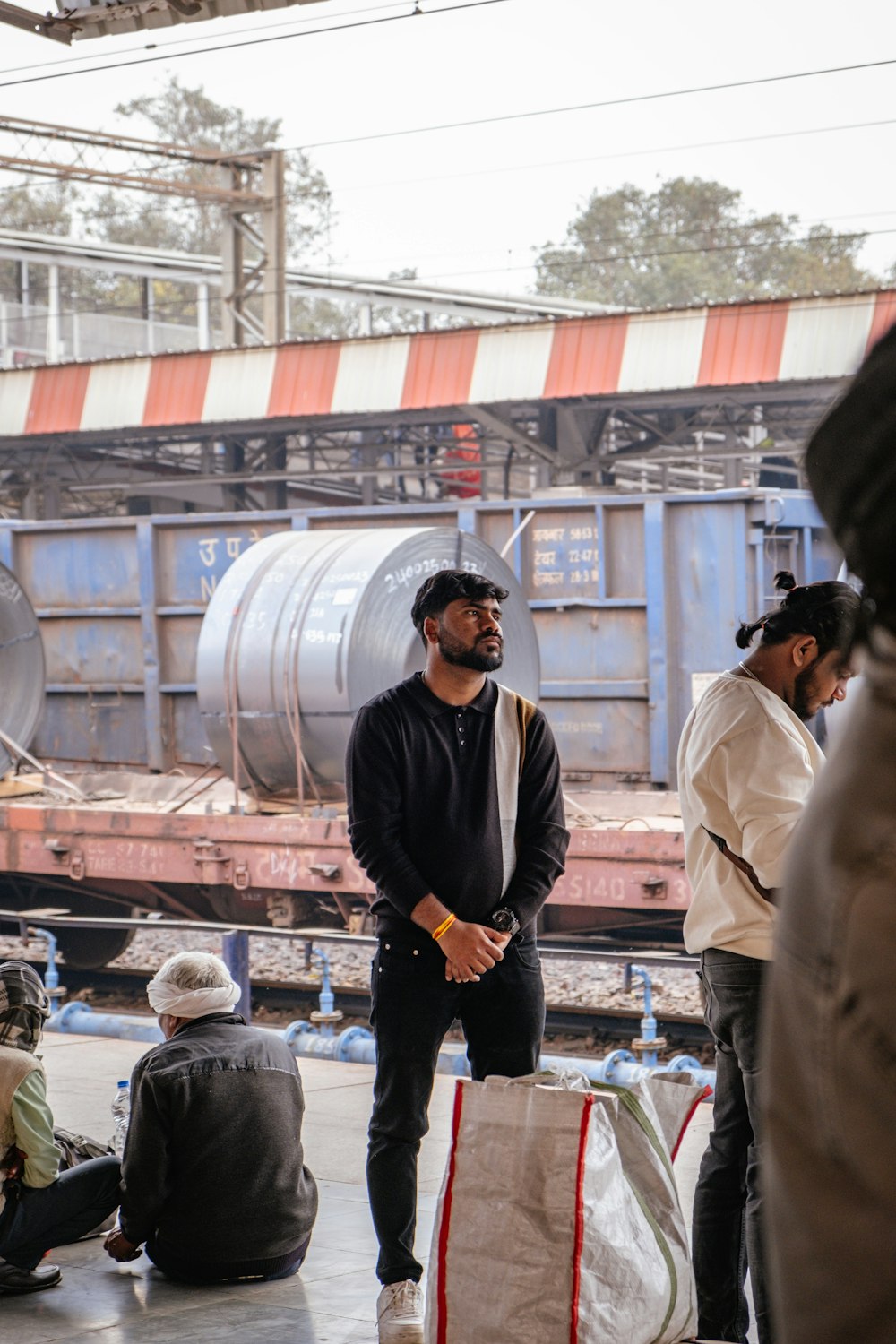 a group of men standing next to each other near a train