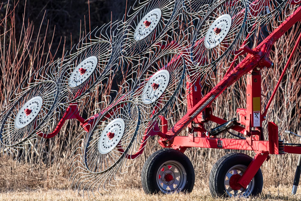 a red tractor is parked in a field