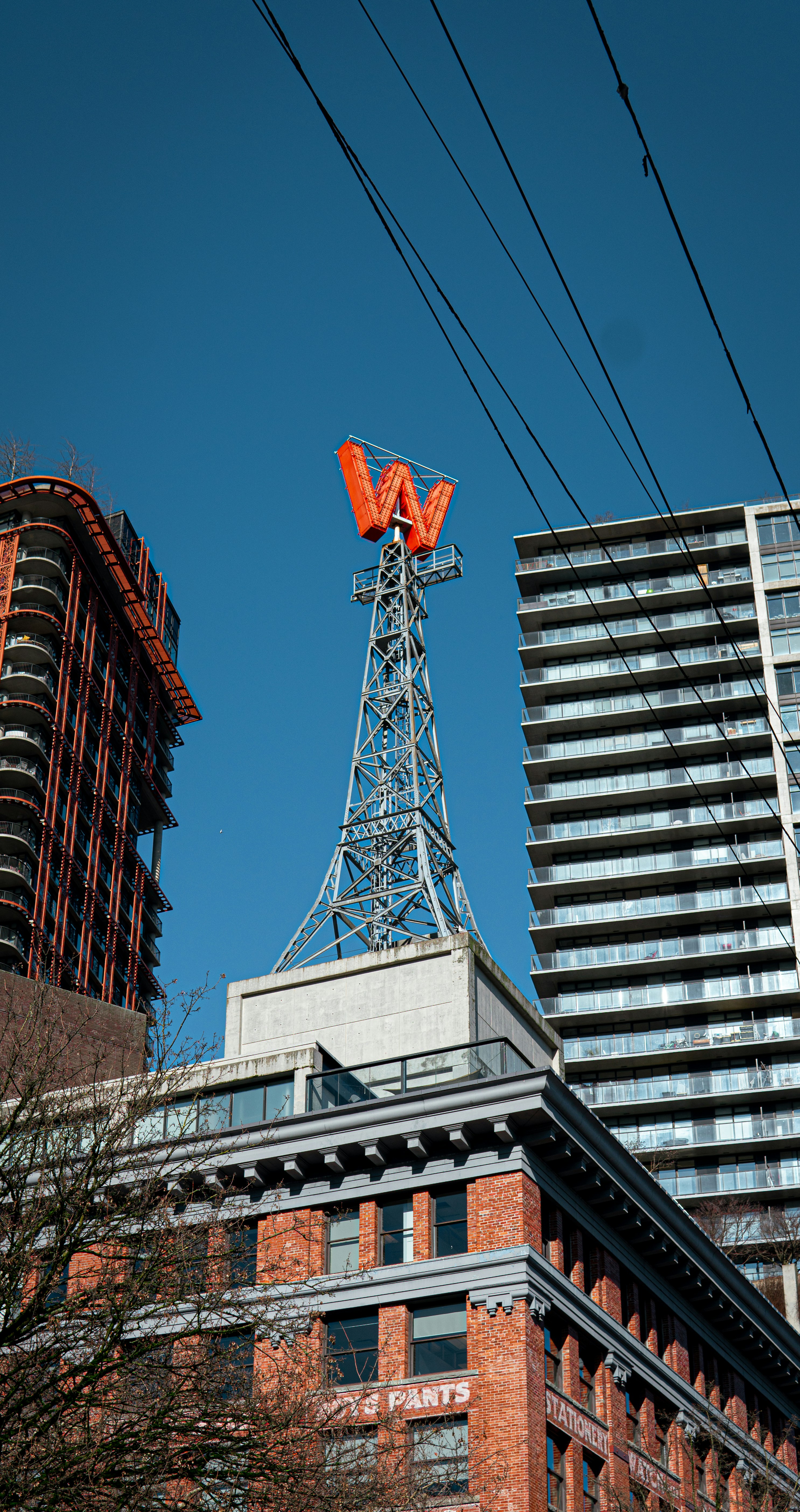 a tall building with a red sign on top of it
