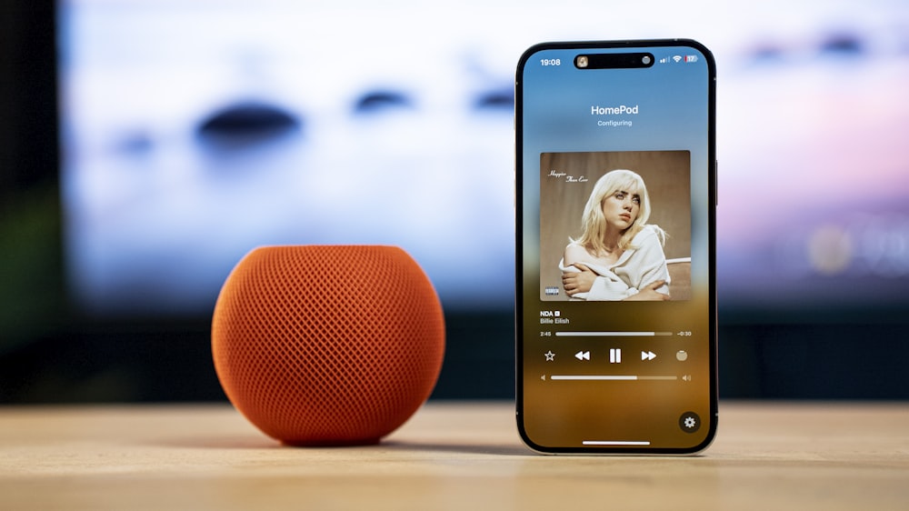 an orange speaker sitting next to an orange speaker