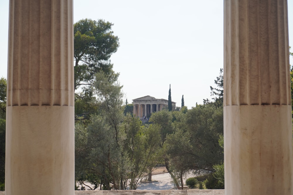 a view of a building through two pillars