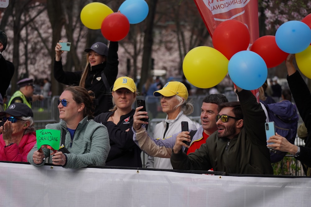 a group of people taking pictures with their cell phones