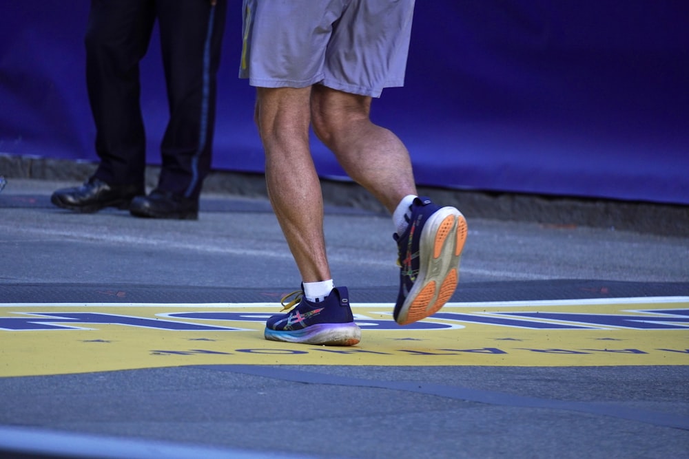 a close up of a person running on a race track