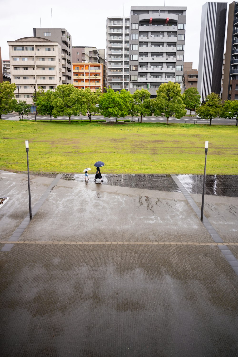 a person walking with an umbrella in the rain