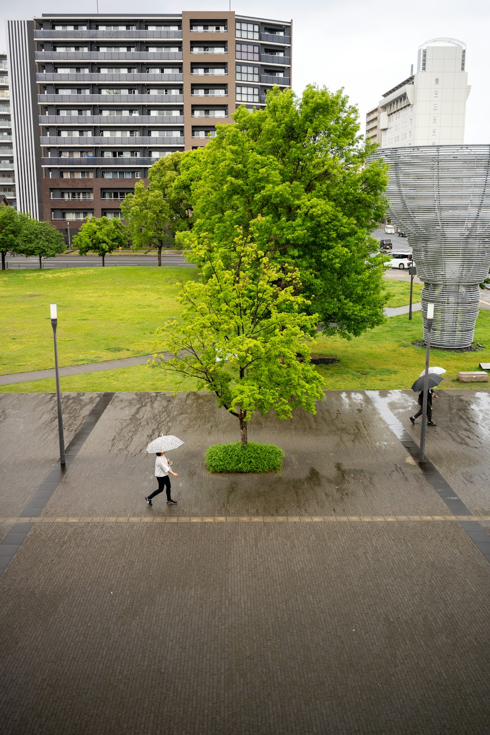 a person walking with an umbrella in a park