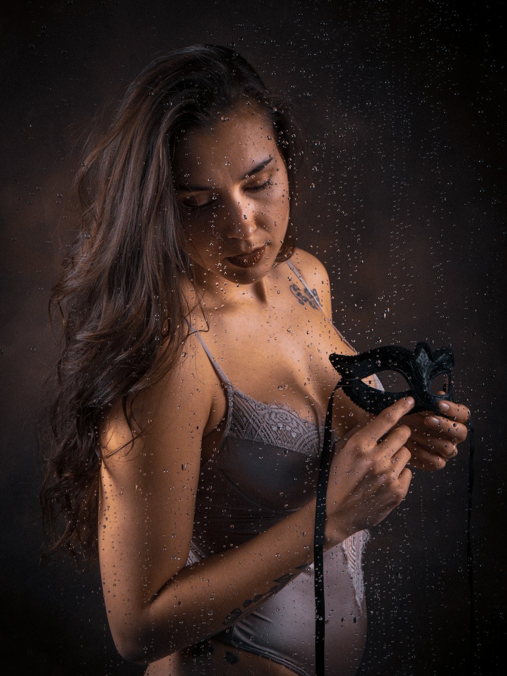 a woman holding a mask in the rain