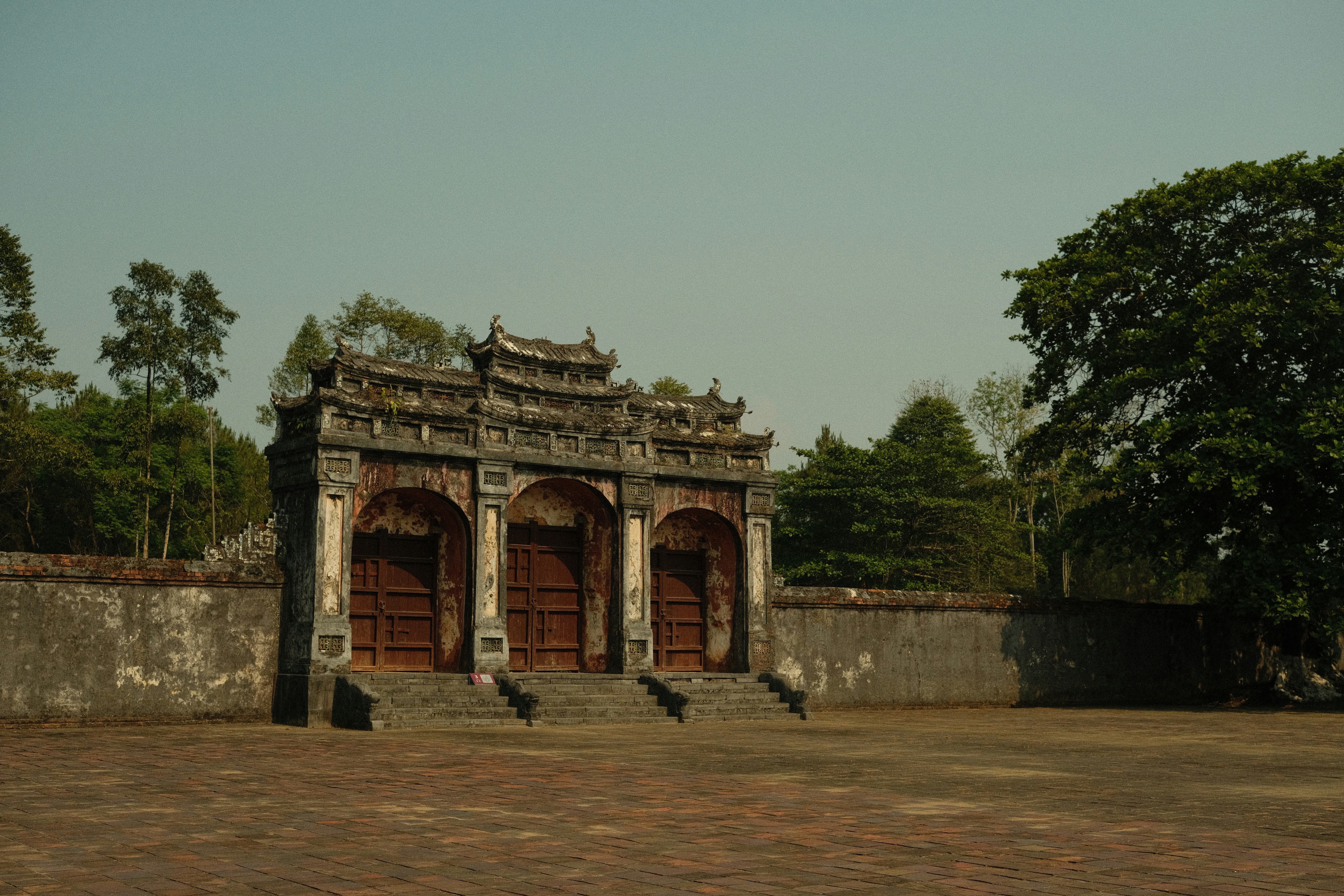 a stone wall with a doorway and steps leading up to it