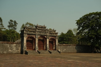 a stone wall with a doorway and steps leading up to it