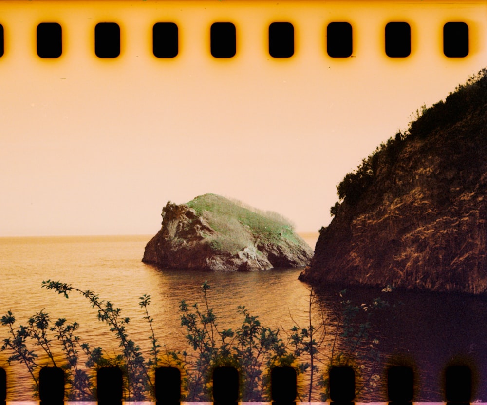 a picture of a rock out in the water